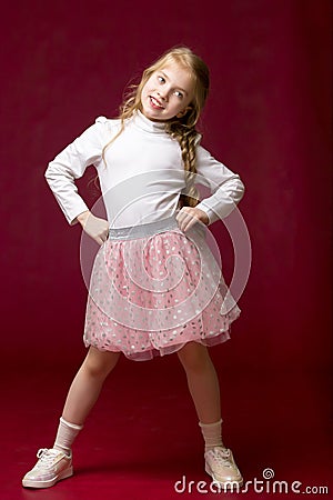 Elegant girl in a dress. Youth fashion concept, happy child. Stock Photo