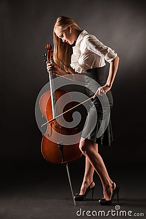 Elegant girl playing with passion on bass-viol Stock Photo