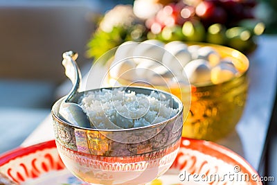 elegant golden bowl for bride and groom give aims food to Buddhist monk in thai traditional wedding Stock Photo
