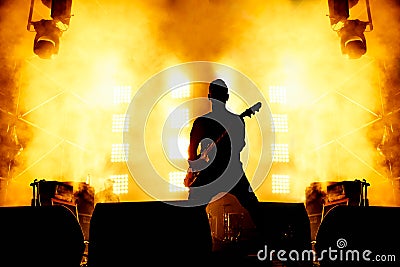 Elegant guitarist silhouette on stage. Editorial Stock Photo