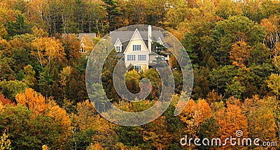 Elegant home on hillside with autumn foliage Stock Photo