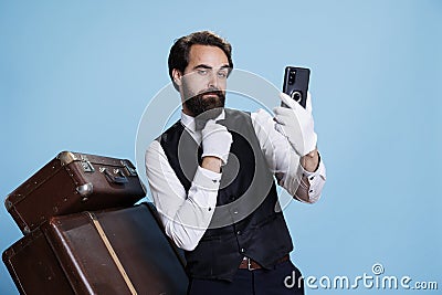 Elegant hotel employee takes photos Stock Photo