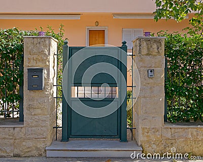 Elegant house external entrance metallic green door Stock Photo