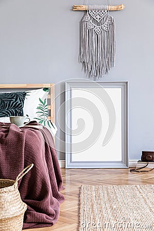 Elegant interior of bedroom with design furnitures, mock up poster frame, mirror, decoration, blanket, pillows. Stock Photo