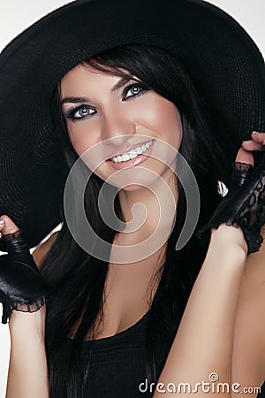 Elegant lady. Happy smiling brunette woman model posing in black Stock Photo