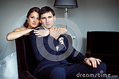 Elegant lovely bride holds the groom's Stock Photo