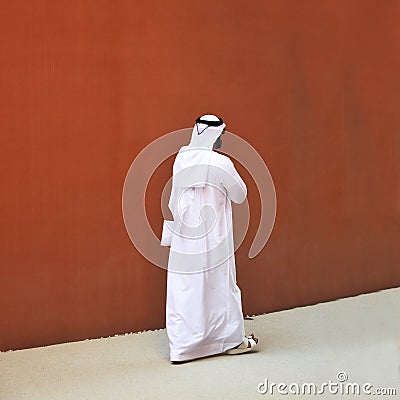 An elegant man of Arab ethnicity with sunglasses walks the streets of his country Editorial Stock Photo