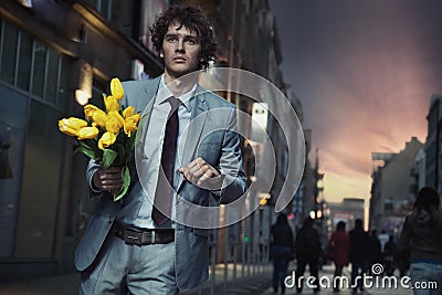 Elegant man holding flowers Stock Photo