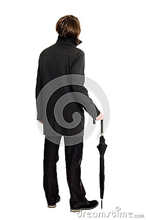 Elegant man in a raincoat standing back Stock Photo