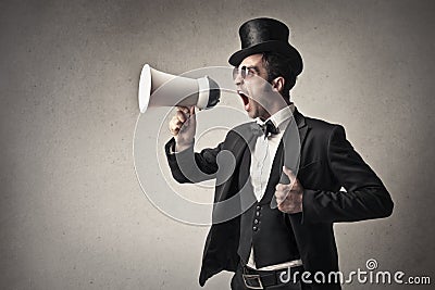 Elegant man screaming into a megaphone Stock Photo