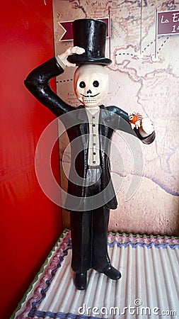 Elegant man skeleton made of paper holding a sugar sheep for the day of the dead celebration Stock Photo