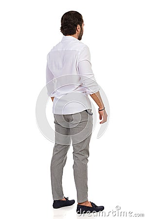 Elegant Man Standing Relaxed. Rear View Stock Photo