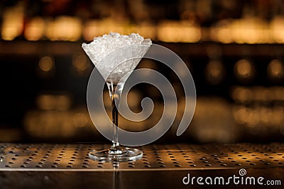 Elegant martini glass filled with ice on the bar Stock Photo