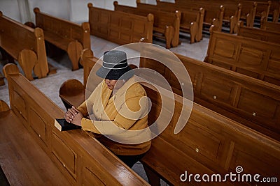 Elegant mature woman praying in church Stock Photo