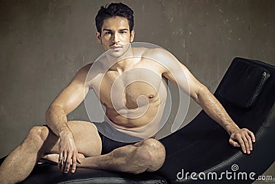Elegant muscular guy in fashion pose Stock Photo