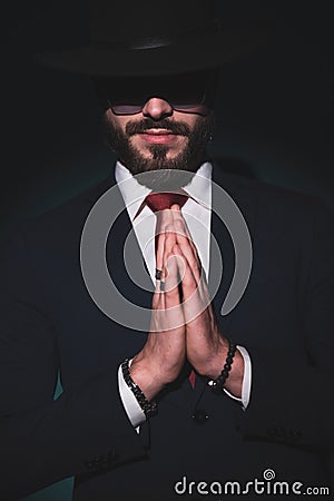 Elegant mysterious businessman holding his hands together Stock Photo