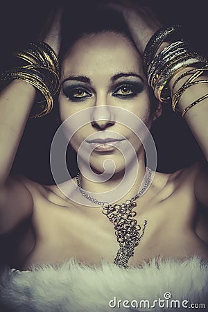 Elegant and sensual woman with golden light, gold and silver Stock Photo