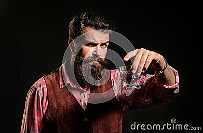 Elegant and stylish man in classical wear holding glass with whiskey in hand. Stock Photo