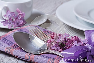 Elegant table setting for breakfast, with flowers lilacs Stock Photo