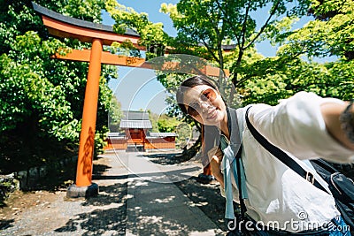 Elegant traveler standing in front of the Torii Stock Photo
