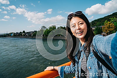 Elegant traveler taking selfie with clean river Stock Photo