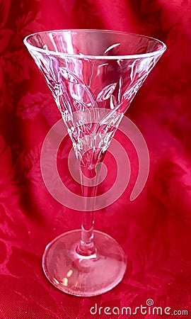 Elegant Vintage Cut Crystal Glass Stemware on Red Background Stock Photo