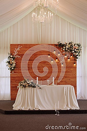 Elegant wedding table in a tent with chandelier and flowers Stock Photo