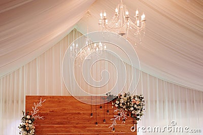 Elegant wedding table in a tent with chandelier and flowers Stock Photo