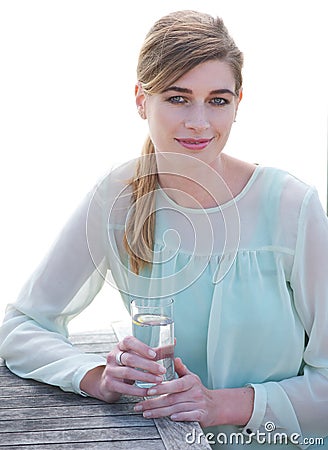 Elegant woman enjoying a cool refreshing drink out Stock Photo