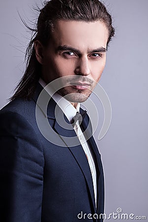 Elegant young handsome long-haired man in costume. Stock Photo