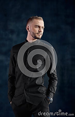 Elegant young handsome modern man. Fashion portrait studio, fashion, successful man. copy space, dark background. Stock Photo