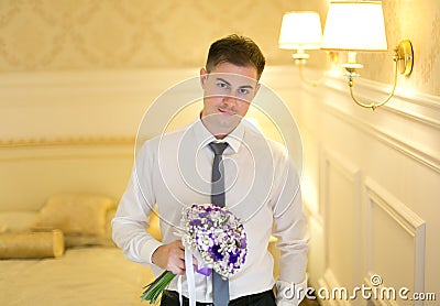 Elegant young man with a bouquet of flowers Stock Photo