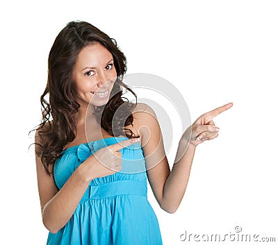 Elegant young woman pointing to the right Stock Photo