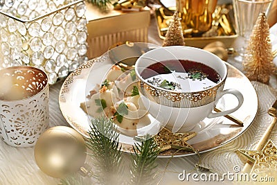 Elegantly served Christmas Eve red borsht with dumplings Stock Photo