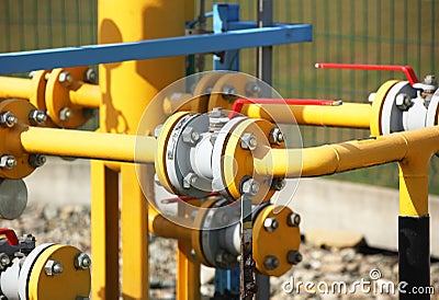 Element gas line high and medium pressure. Yellow transport pipes on the surface of the fence. Regulatory supply system for Stock Photo