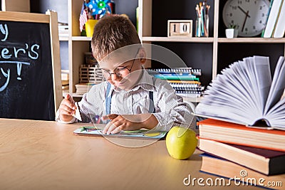 Elementary school. Back to school. Kid is learning in class on background of blackboard. Educational games and toys. Close up Stock Photo