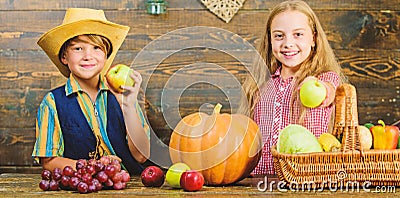 Elementary school fall festival idea. Celebrate harvest festival. Kids girl boy fresh vegetables harvest rustic style Stock Photo