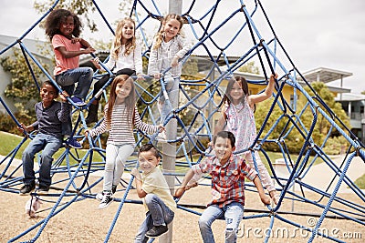 Elementary school kids climbing in the school playground Stock Photo