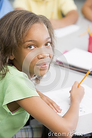 Elementary school pupil at desk Stock Photo