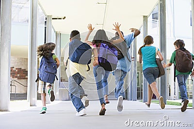 Elementary school pupils running outside Stock Photo