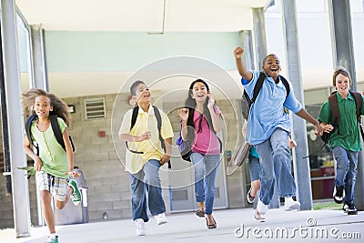 Elementary school pupils running outside Stock Photo