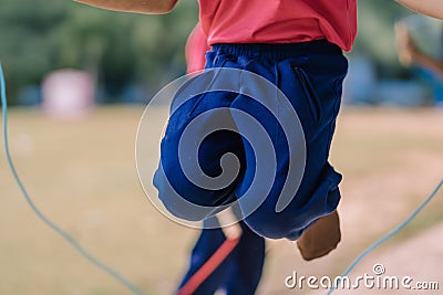 Elementary school students enjoy rope jump training for good hea Stock Photo