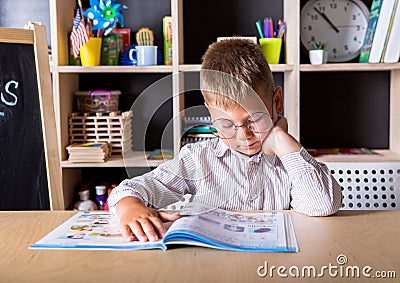 Elementary school. Talented child. Teachers day. School kids. Back to school. Kid is learning in class on background of blackboard Stock Photo