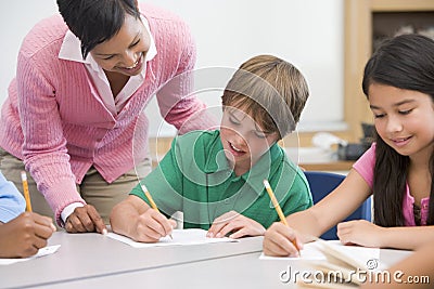 Elementary school teacher helping pupil Stock Photo