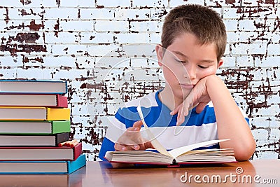 Elementary schoolboy focusing on his studies Stock Photo