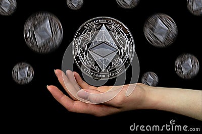 Elements of the ethereum classic cryptocurrency fall on the hand Editorial Stock Photo