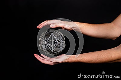 Elements of the ethereum classic cryptocurrency fall on the hand Editorial Stock Photo