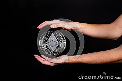 Elements of the ethereum classic cryptocurrency fall on the hand Editorial Stock Photo