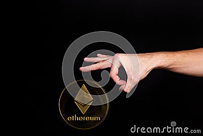 Elements of the ethereum cryptocurrency fall on the hand Editorial Stock Photo