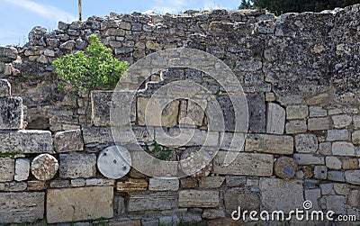 The elements of the wall of a ruined ancient house. Beautiful background of the ruins of Greek cities. Stock Photo